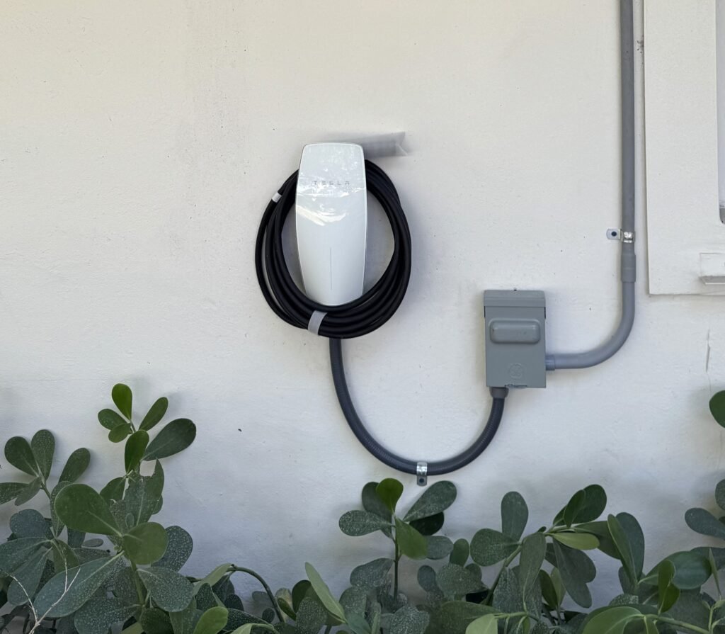 Tesla wall connector EV charger installation with disconnect on residential home in Miami-Dade County